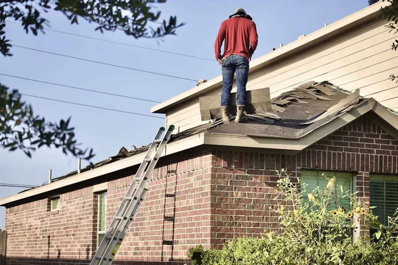Professional roofer working on a residential roof in Brick Store